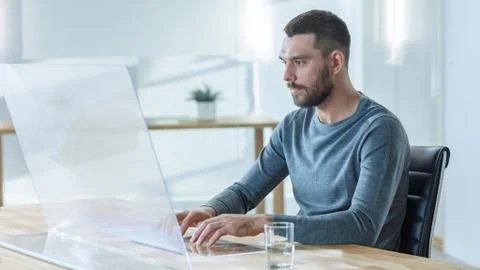 In the Near Future Stylish Man Uses His High-Tech Computer with Transparent Stock Photos