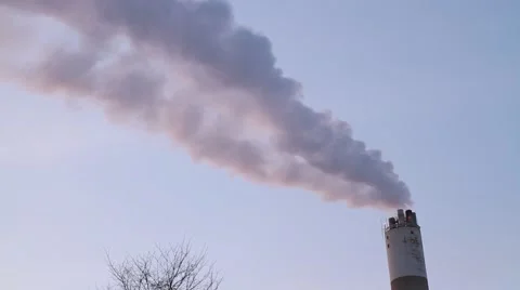 Near sunset - Smoke from chimney stack against sky Stock Footage 59096557
