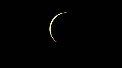 Near Total Solar Eclipse with Crescent Sun Shape with Moon Obscuring Nearly All Stockbeeldmateriaal 345937967