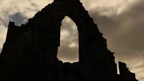 Near-total solar eclipse through ruined abbey window Stock Footage 75016723