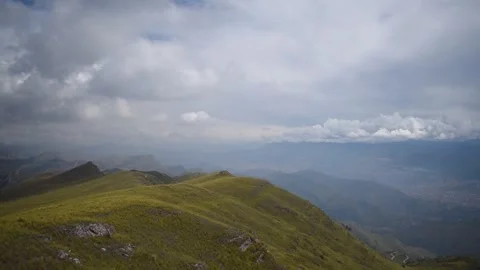Nearby mountain range with cloudy sky in the background Stock Footage 274512966