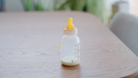 Nearly Empty Baby Formula Bottle on Table Inside Home Stock Footage 344021086