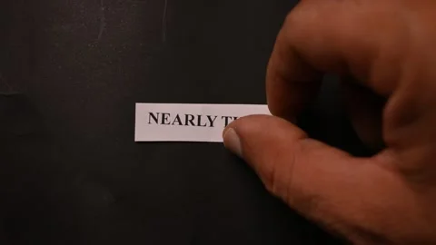 Nearly There Progress Concept with Paper Note on Black Texture Surface Stock Footage 338239545