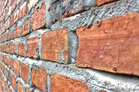 A neat arrangement of red bricks held together with cement adhesive. 写真素材