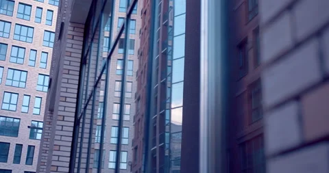 Neat bricks in modern brickwork and large glass windows reflecting building Stock Footage 119619326