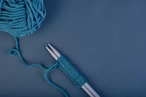 Neat even loops of threads for knitting in green color on knitting needles, n 写真素材