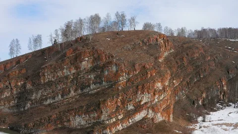 Neat flight from a cliff with trees.  Aerial video. Stock Footage 127635208