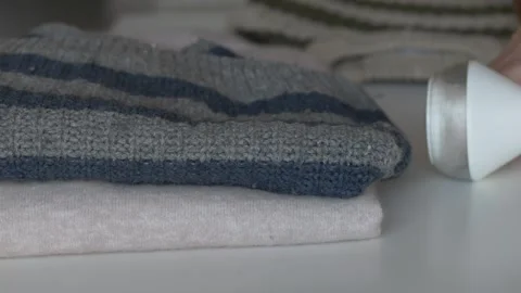 Neat folded sweater ready for reuse or charity donation after fabric shaver Stock Footage 331010469