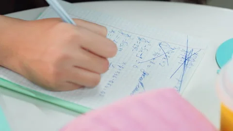 Neat hand script on graph paper. Organized study space with colorful school Video stock 331360830