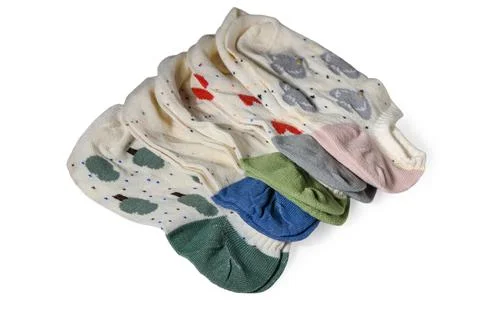 Neat stack of folded white ankle socks with diverse patterns and colorful hee Stock Photos
