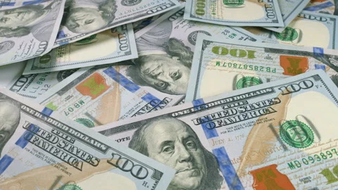 A neat stack of hundred dollar bills on a surface, highlighting the value of cas Stock Footage 303569776