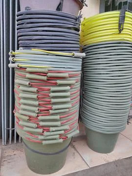 Neat stack of multi-colored buckets in a builder's shop Stock Photos