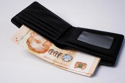 A neat stack of Singapore 100 dollar sticking out from the main pocket of a.. Stock Photos