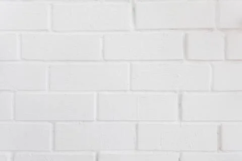 Neat white painted brick wall with a distinct texture Stock Photos