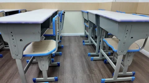Neatly Aligned Student Desks and Chairs in Empty Classroom, Low Angle Wide Shot Stock Footage 339326889
