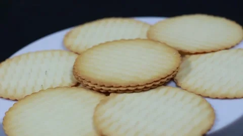 Neatly Arranged Thin Plain Biscuits on Rotating Display Stock Footage 280136741