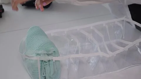 Neatly folded clothes in the organizer boxes for wardrobe. Marie Kondo tidying Stock Footage 241024278