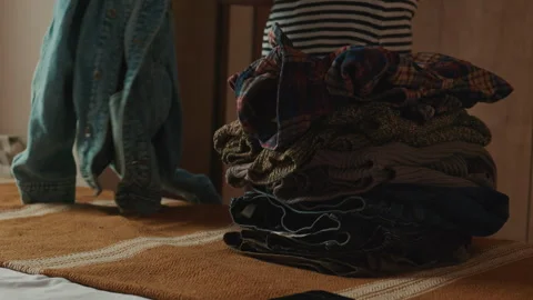 Neatly Folding And Stacking Clothes In A Home Setting Stock Footage 333152178