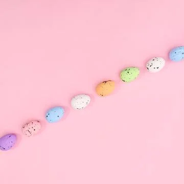 Neatly layout of Easter colorful eggs on pastel bright pink background. Flat  Stock Photos