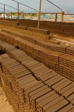 Neatly stacked clay bricks Stockfoto's