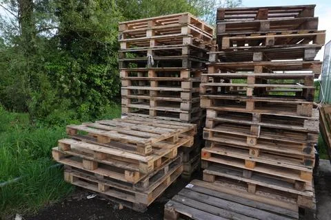 Neatly stacked pallets form uniform piles - Northern Ireland, 04.06.2024 Stock Photos