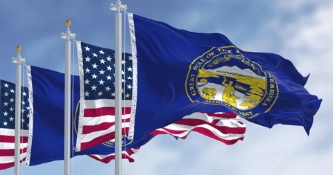 Nebraska state flags waving with the American flag Video stock 333767530