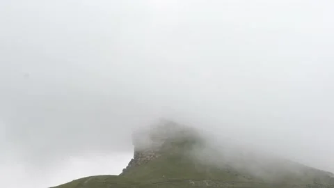 Nebula and clouds falling on the green top of the mountain Stock Footage 166548497
