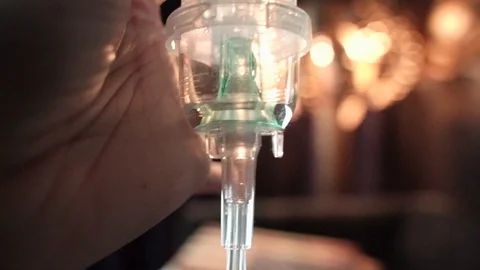 Nebulizer cup with medication closeup and pan up showing nebulizer assembly Stock-Footage 118673507