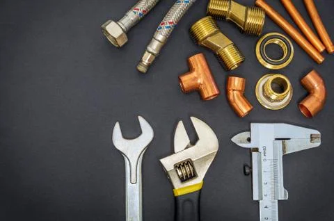 Necessary set of tools and spare parts for plumbing isolated on black backgro Stock Photos