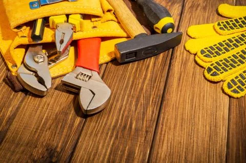 Necessary set of tools in the bag for plumbers on a vintage wooden background Stock Photos