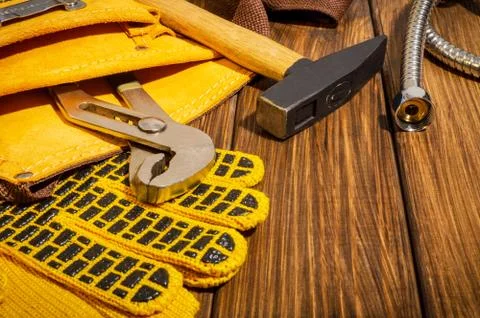 Necessary set of tools in the bag for plumbers on a vintage wooden background Stock Photos