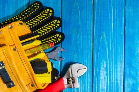 A necessary set of tools in a bag on a vintage blue wooden background. Stock Photos