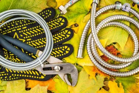 Necessary set tools for plumbers on on background of yellow leaves Stock Photos