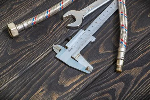 Necessary set of tools for plumbers on black vintage wooden boards with space Stock Photos