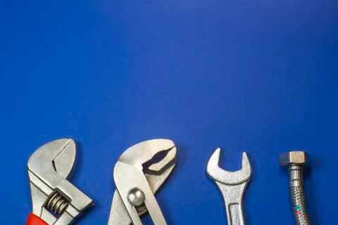 Necessary set of tools for plumbers on a blue background. Stock Photos