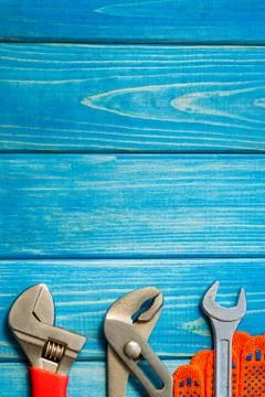 Necessary set of tools for plumbers on a blue wooden background. Stock Photos