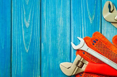 Necessary set of tools for plumbers on a blue wooden background. Stock Photos