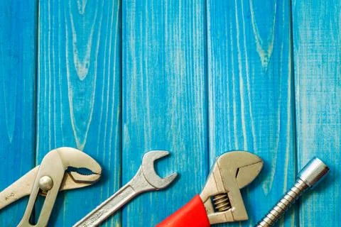 Necessary set of tools for plumbers on a blue wooden background. Stock Photos