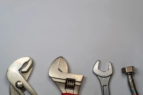 Necessary set of tools for plumbers on a gray background. Stock Photos