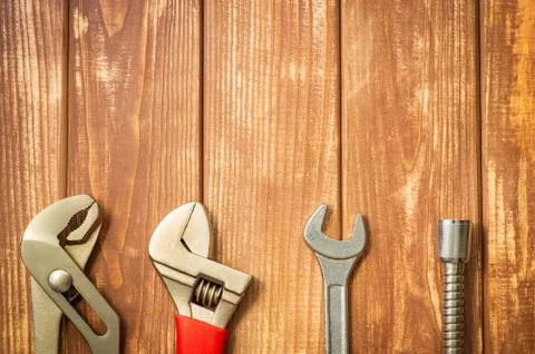 Necessary set of tools for plumbers on a vintage wooden wooden background. Stock Photos