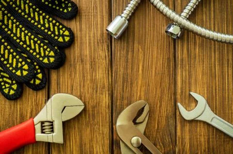 Necessary set of tools for plumbers on a vintage wooden background. Stock Photos