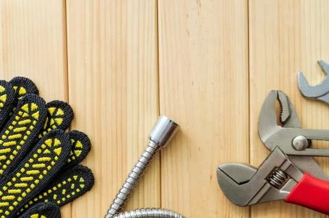 Necessary set of tools for plumbers on a wooden background. Stock Photos