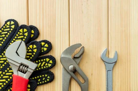 Necessary set of tools for plumbers on a wooden background. Stock Photos