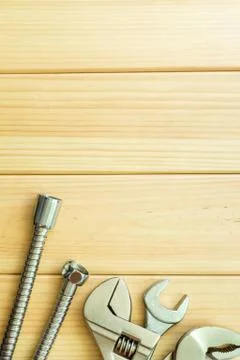 Necessary set of tools for plumbers on a wooden background. Stock Photos