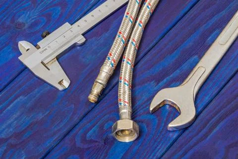 Necessary set of tools for plumbers on wooden blue boards with space for adve Stock Photos