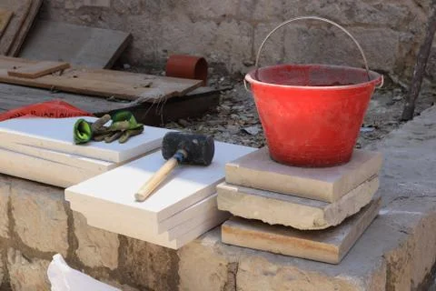 Necessary tools for construction - rubber hammer, bucket and gloves. Construc Stock Photos