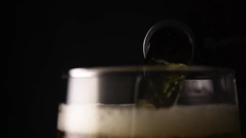 Neck of the bottle with pouring beer Stock Footage 72646558