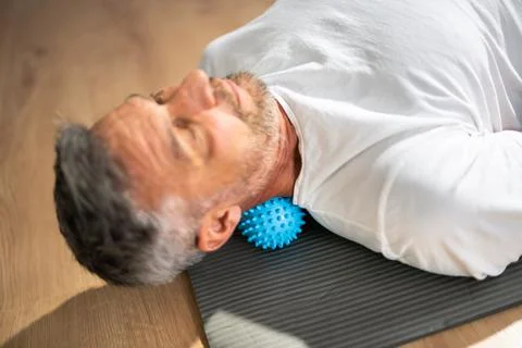 Neck Trigger Point Massage Using Spiky Ball Stock Photos