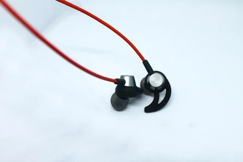 Neckband image. Bluetooth headset image. Red wired bluetooth earphones. Stock Photos