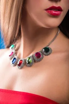 Necklace on the neck. ruby and emerald Stock Photos